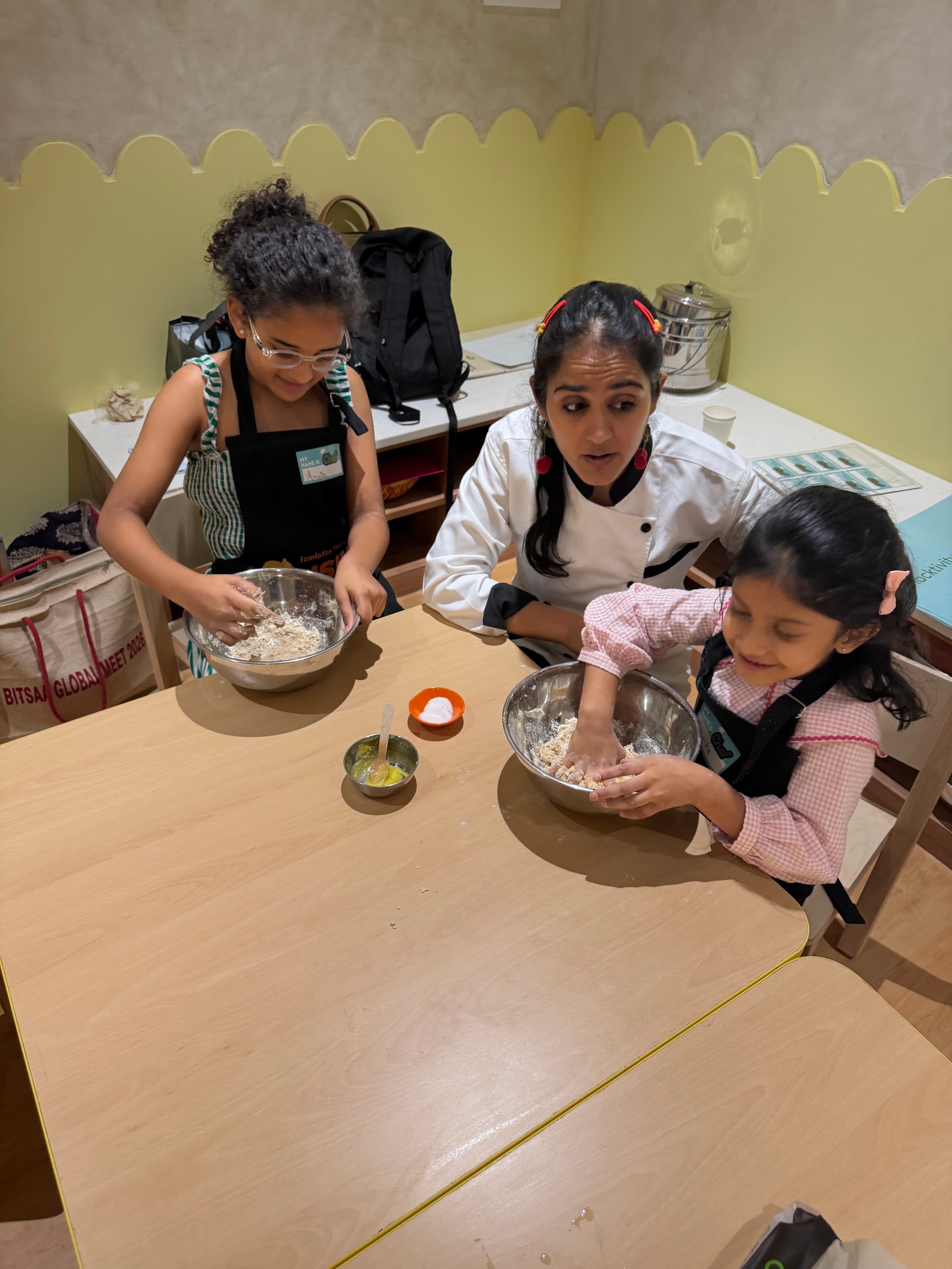 Children baking together with a chef